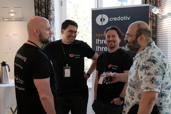 A group of attendees talking during a break